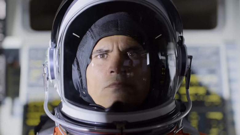 José M. Hernández (Michael Peña) frowns in his spacesuit in A Million Miles Away