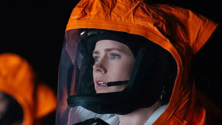 Louise Banks (Amy Adams) wears an orange contamination suit in Arrival