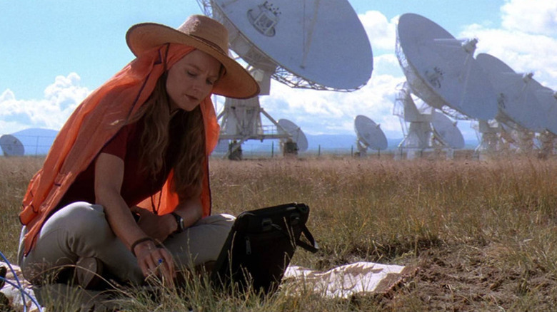 Ellie Arroway (Jodie Foster) checks readings by an array of satellite dishes in Contact (1997)