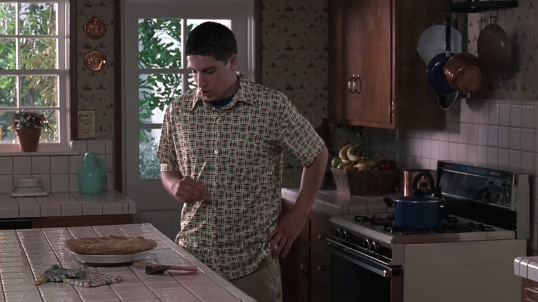 Jason Biggs as Jim, staring down at an apple pie in the kitchen, in American Pie