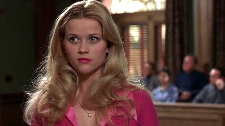 Reese Witherspoon as Elle Woods wearing a pink dress in a courtroom in Legally Blonde