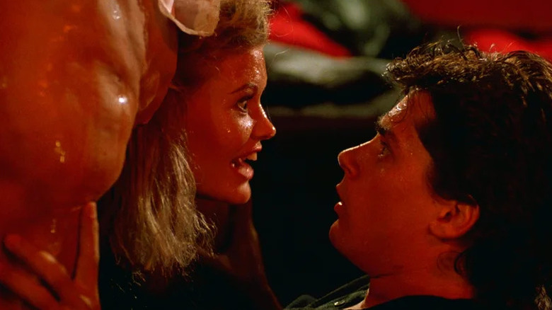 Billy Warlock as Bill looking at head of Patrice Jennings as Jenny coming out of someone's body, bathed in red light in Society