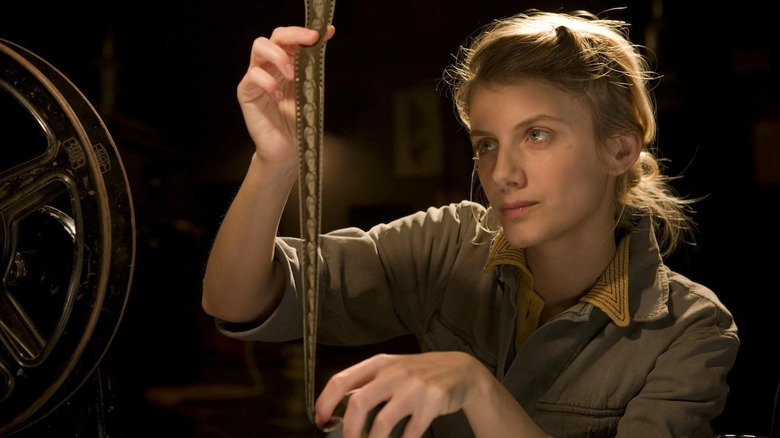Shosanna Dreyfus (Mélanie Laurent) examines a roll of film in Inglourious Basterds
