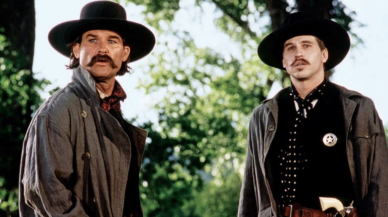 Wyatt Earp (Kurt Russell) and Doc Holliday (Val Kilmer) look concerned in Tombstone