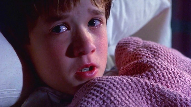 Cole looking scared lying in bed in The Sixth Sense