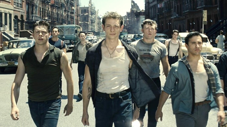Mike Faist as Riff leading the Jets down the street in West Side Story