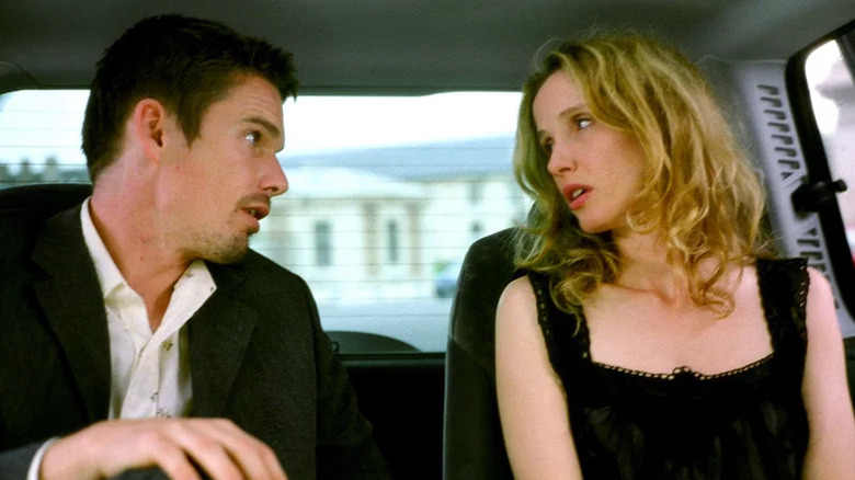 Jesse (Ethan Hawke) speaks with Céline (Julie Delpy) in the back of a car in Before Sunset