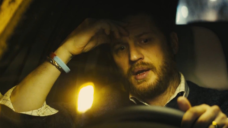 Ivan Locke (Tom Hardy) puts his hand on his forehead as he drives in Locke