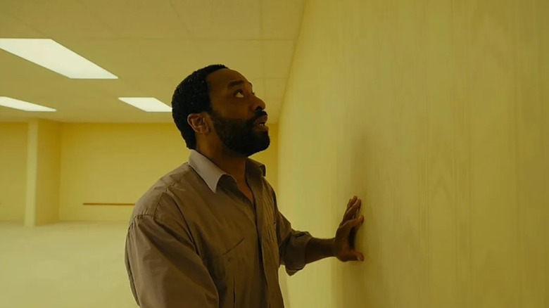 Clark staring at a wall scared in Backrooms