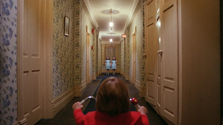 Danny riding his tricycle towards the twins in The Shining