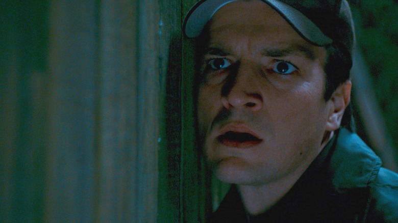 Bill Pardy (Nathan FillIon) learning against wall in Slither