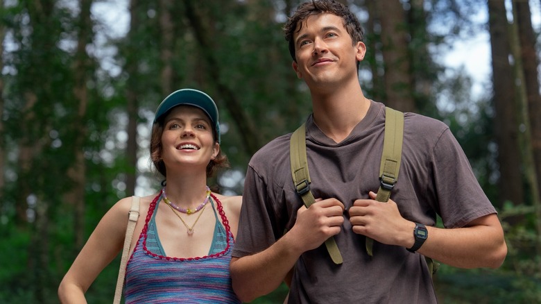 Poppy and Alex hiking in the woods in People We Meet on Vacation