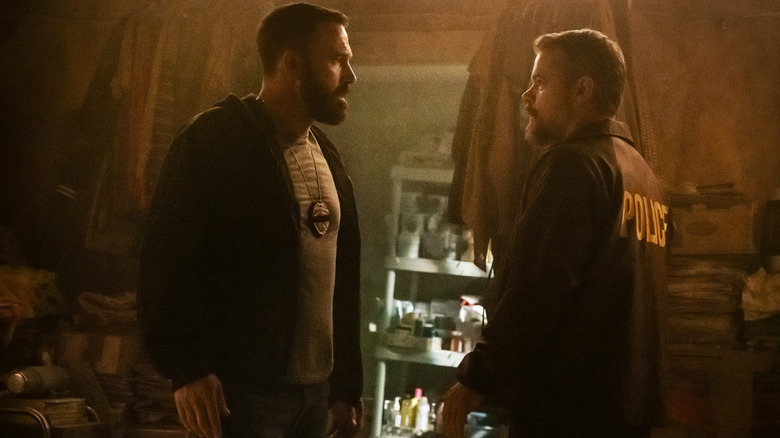 Ben Affleck as JD Byrne and Matt Damon as Dane Dumars in a heated conversation with each other in a derelict house in The Rip