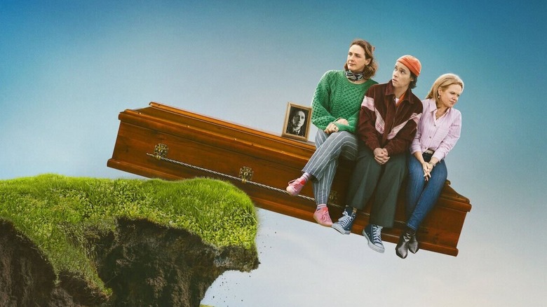 How to Get to Heaven from Belfast - Saoirse, Yara and Robyn sitting on coffin leaning off of ledge