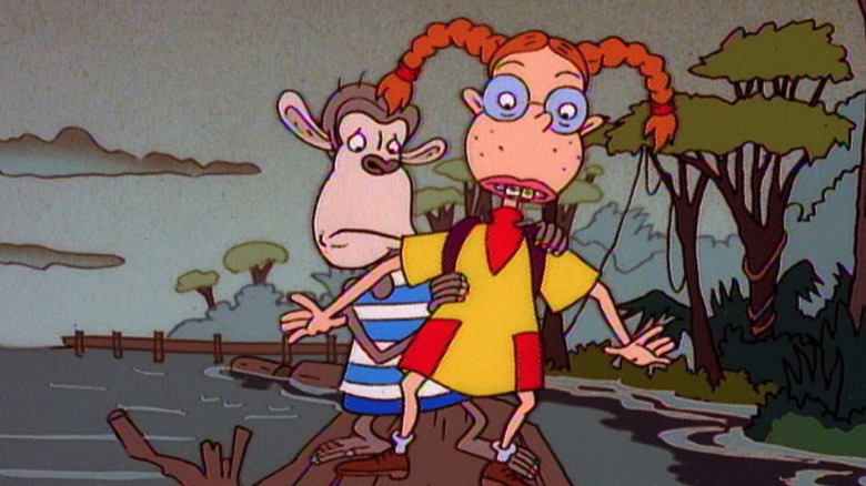 Eliza and Darwin balance on a log on a river in The Wild Thornberrys