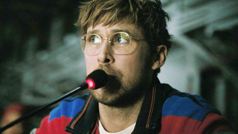 Ryan Gosling as Ryland Grace sitting with a microphone next to his mouth in Project Hail Mary
