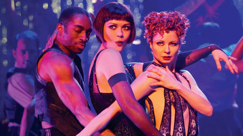 Catherine Zeta-Jones as Velma Kelly performing with two dancers in Chicago.