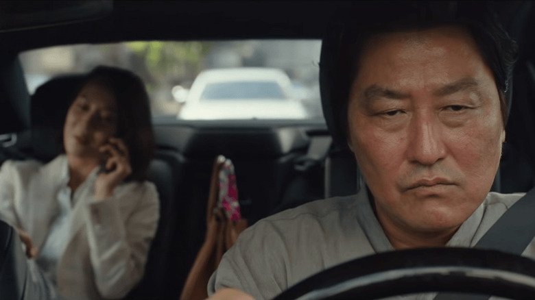 Song Kang-ho as Kim Ki-taek, driving Cho Yeo-jeong as Choi Yeon-gyo in Parasite.