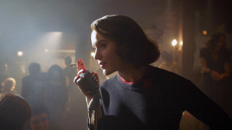 Rachel Brosnahan as Miriam Maisel, speaking into a mic at a club, in The Marvelous Mrs. Maisel.