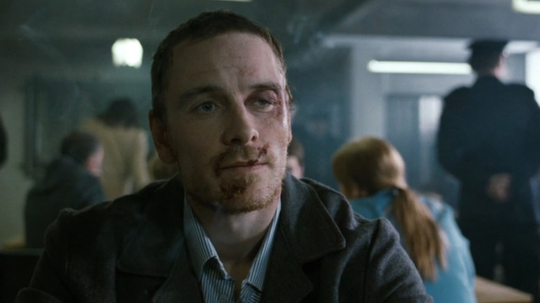 Injured Bobby Sands (Michael Fassbender) sitting in visiting room in Hunger