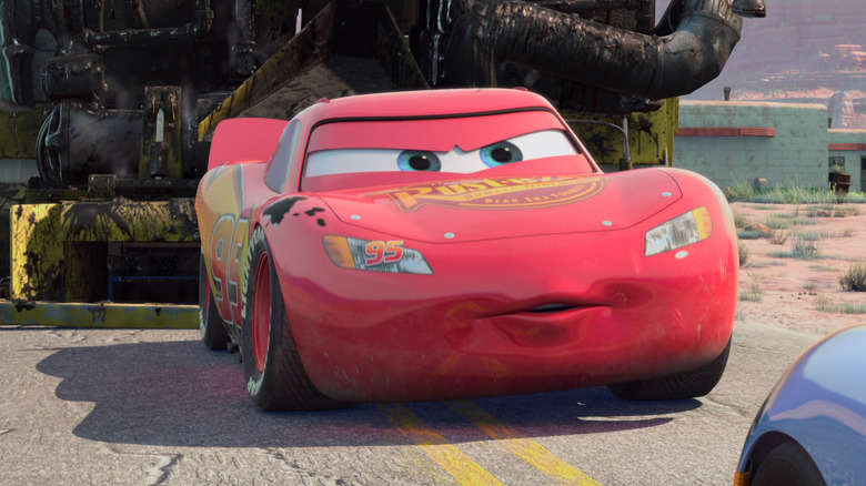 Lightning McQueen (Owen Wilson) tows a street paver in Cars (2006)