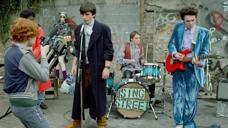 Percy Chamburuka, Ben Carolan, Ferdia Walsh-Peelo, Conor Hamilton, and Mark McKenna as Ngig, Darren, Conor, Larry, and Eamon recording footage for their music video in Sing Street