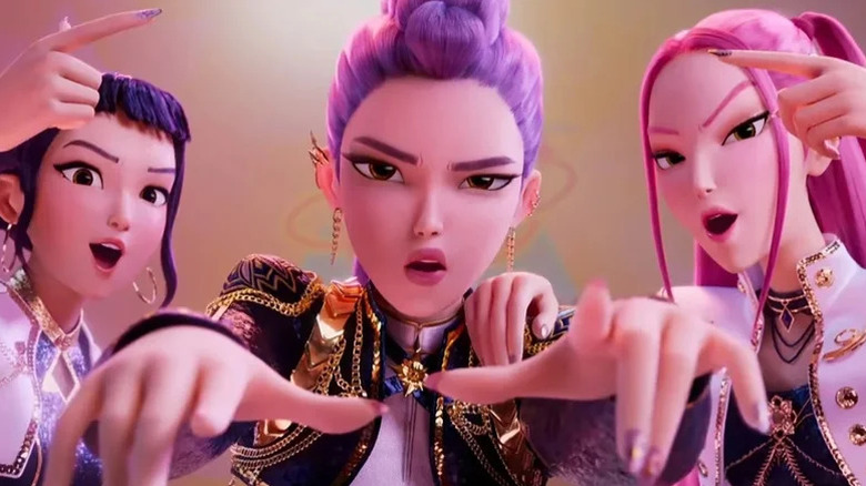 Zoey, Rumi, and Mira perfomring as HUNTR/X in K-Pop Demon Hunters