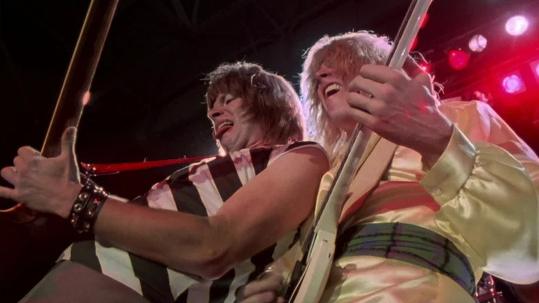 Christopher Guest and Michael McKean as Nigel Tufnel and David St. Hubbins rocking out onstage in This Is Spinal Tap