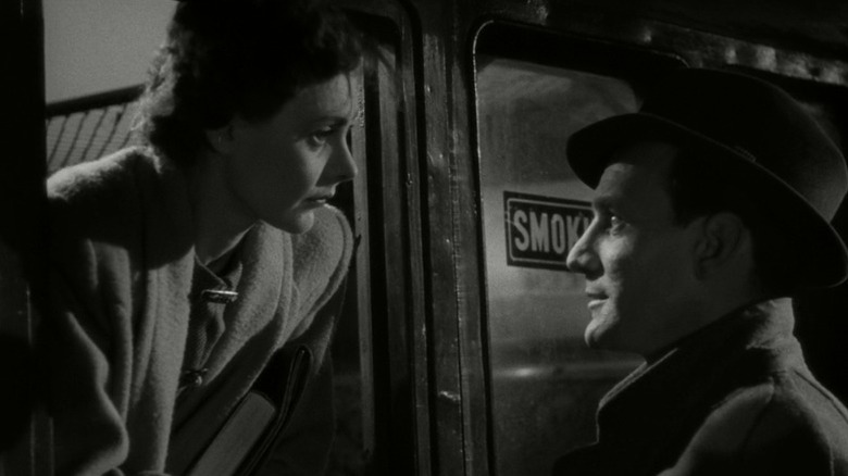 Celia Johnson as Laura Jesson leaning out of a train window and locking eyes with Trevor Howard as Alec Harvey in Brief Encounter