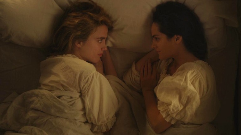 Adèle Haenel as Héloïse and Noémie Merlant as Marianne smiling at each other in bed in Portrait of a Lady on Fire