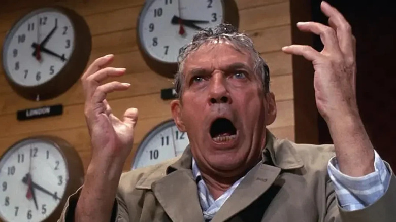 Howard Beale (Peter Finch) screaming in front of clocks in Network