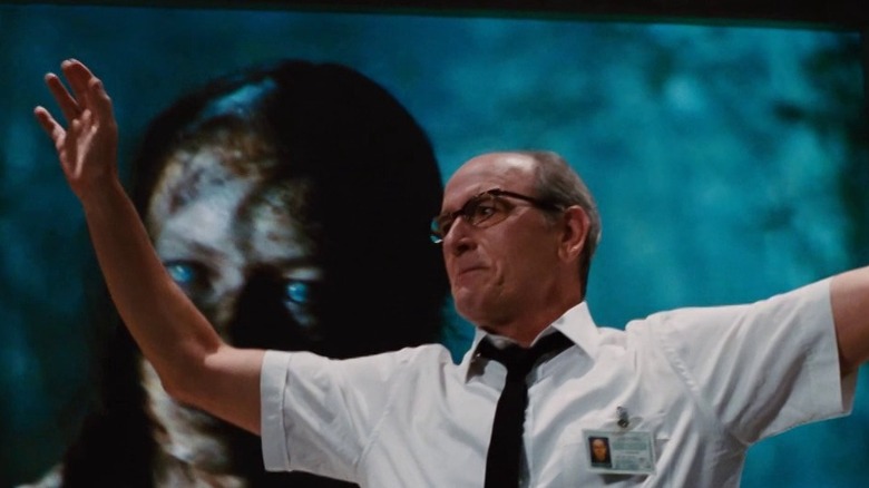 Gary Sitterson (Richard Jenkins) holding up his arms in The Cabin in the Woods