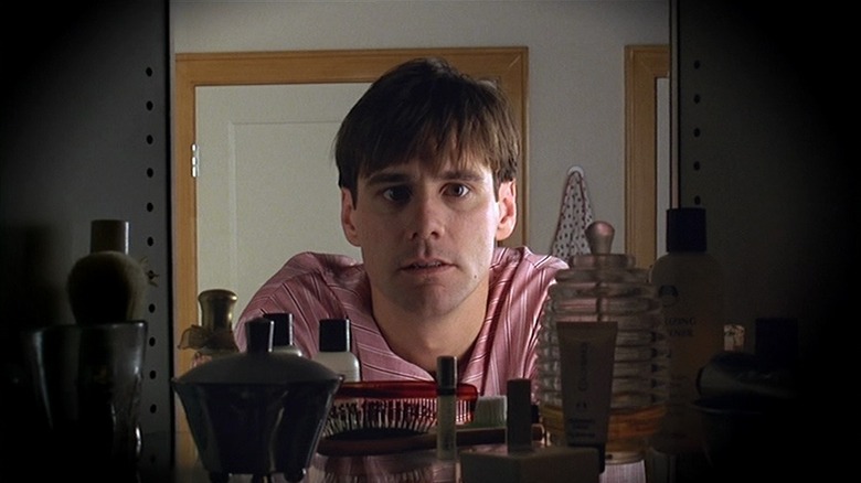 Truman Burbank (Jim Carrey) looking in his medicine cabinet in The Truman Show