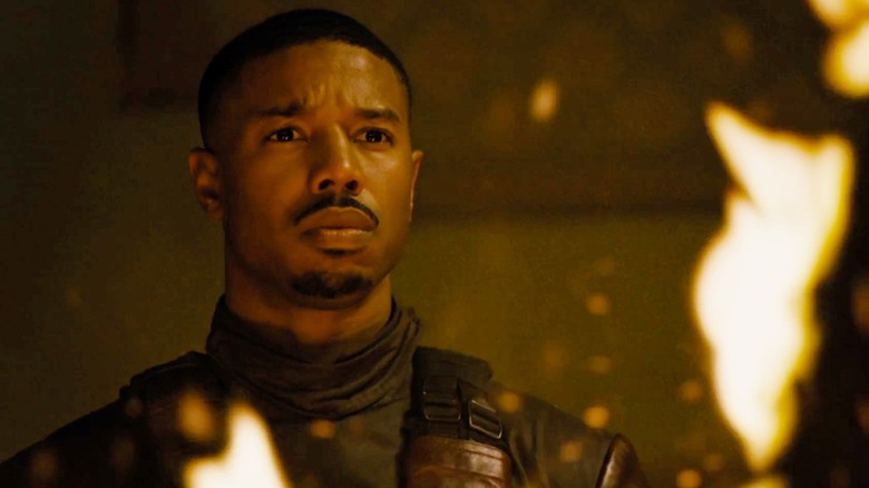 Michael B Jordon, as Guy Montag, a Fireman, watches books burn in Fahrenheit 451