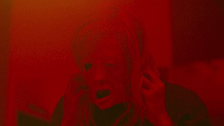Tasya Vos (Andrea Riseborough) adjusts her mask in Possessor
