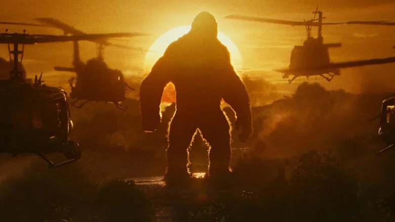 A group of helicopters approach Kong during sunset in Kong: Skull Island