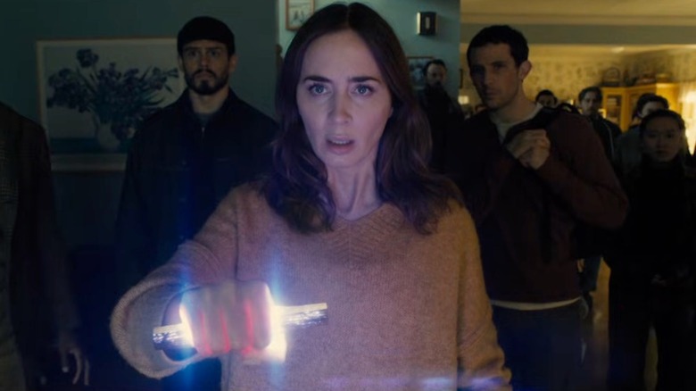 Emily Blunt as Margaret Fairchild wields the alien "thingy" in Disclosure Day