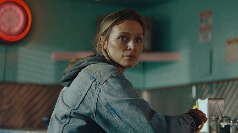 Irene sitting at a diner in Redux Redux