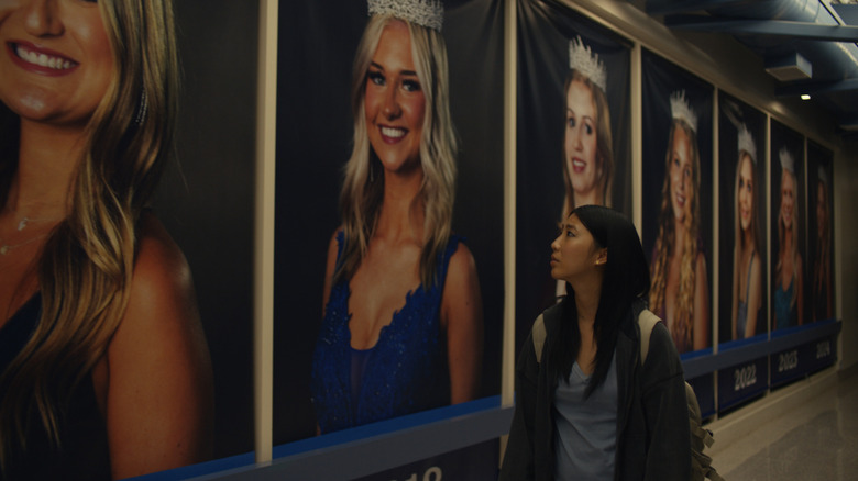 Joan stares at portraits of white beauty queen winners in Slanted