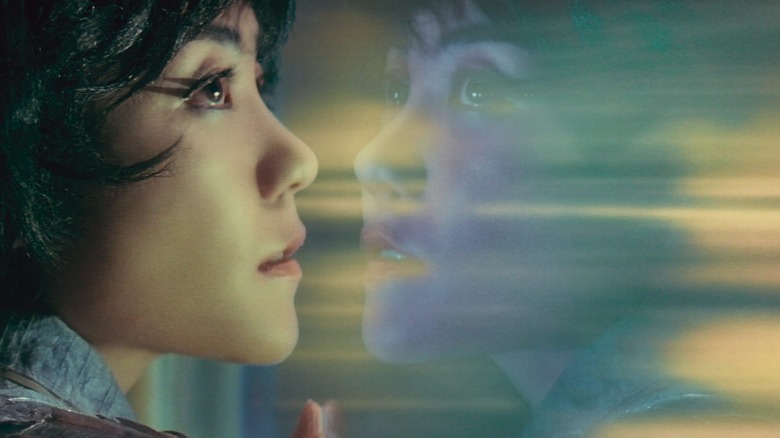 Wang Jing-wen looks out a window with her reflection in 2046