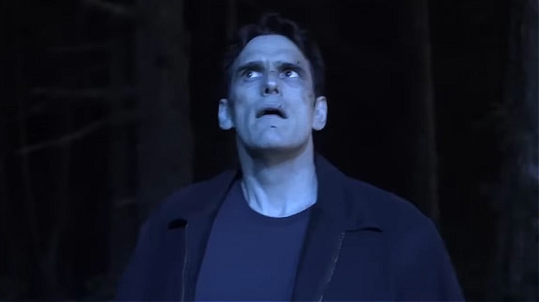 Ethan Burke (Matt Dillon) lying on leaves bloodied on Wayward Pines
