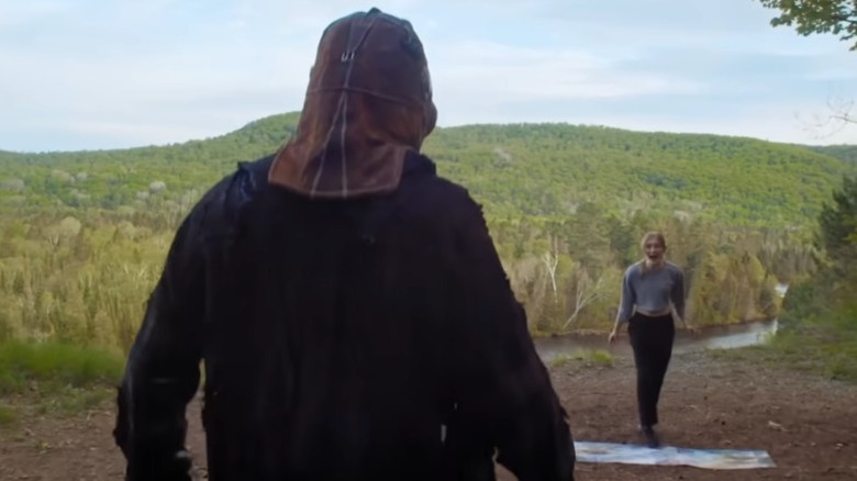 The back of Johnny's bloody head as he walks toward a house, from In a Violent Nature