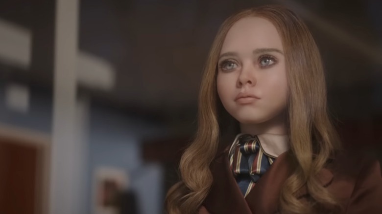 The M3GAN doll with her face cut and her hair burned in M3GAN