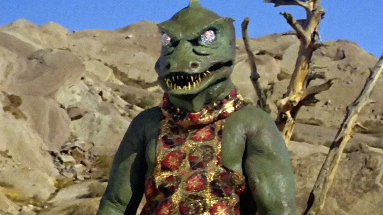 A Gorn stands by a barren tree in Star Trek: The Original Series