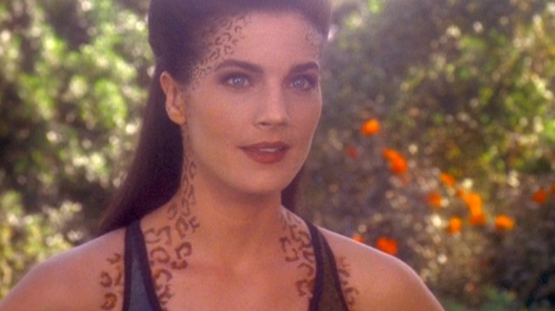 Jadzia Dax (Terry Farrell) stands in a hazy forest in Star Trek: Deep Space Nine