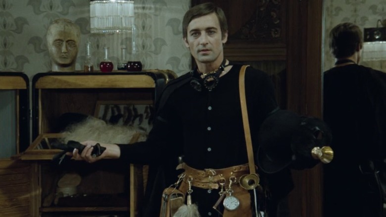 Michal Dočolomanský as Nick Carter opening his arms while wearing a utility belt in Adela Has Not Had Supper Yet