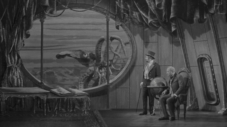 Miloslav Hholub as Count Artigas and Arnošt Navrátil as Professor Hoch seeieng a giant octopus through a submarine window in Invention for Destruction