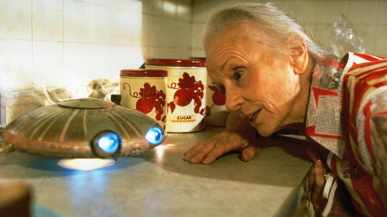 Faye (Jessica Tandy) looks at flying saucer in batteries not included