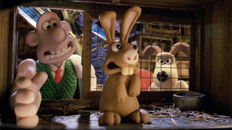 Wallace (Peter Sallis) reaching for a rabbit while Gromit watches in Wallace & Gromit: The Curse of the Were-Rabbit