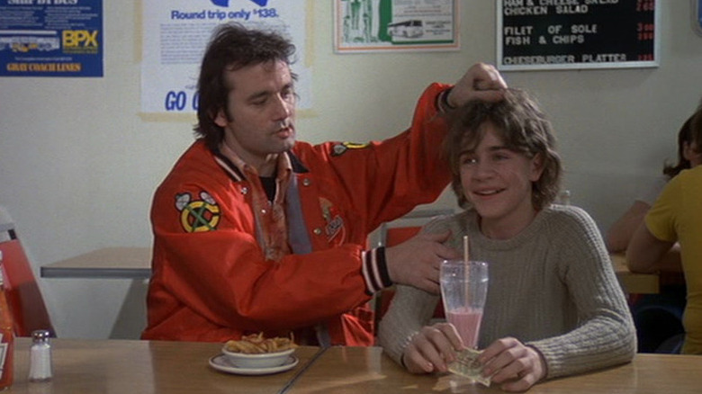 Tripper (Bill Murray) rubs Rudy's (Chris Makepeace) head in Meatballs